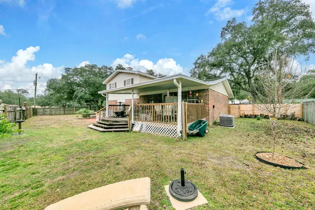 a view of backyard with wooden fence