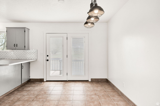 365 South Center Street Fielding, UT 84311 - Photo 11 of 41 Unfurnished dining area with light tile patterned floors and baseboards