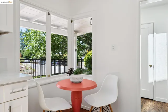 a view of a dining room with furniture a chandelier and wooden floor