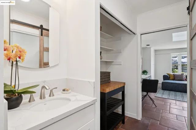 a en suite bathroom with a sink double vanity and a mirror