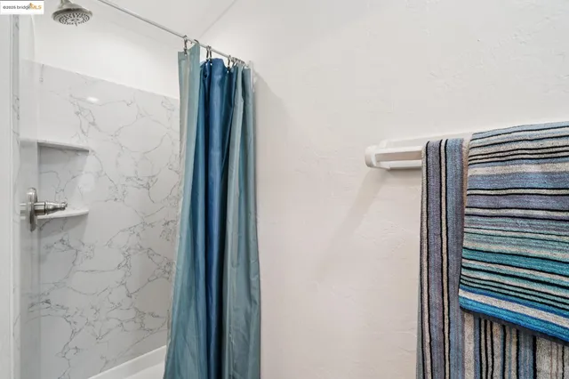 a bathroom with a shower and a mirror