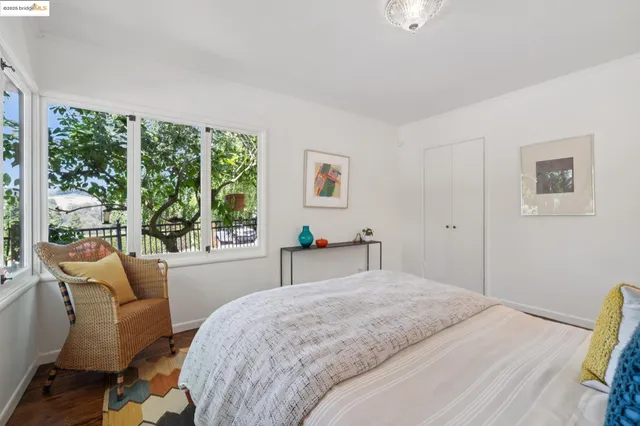 a bedroom with a bed and a large window