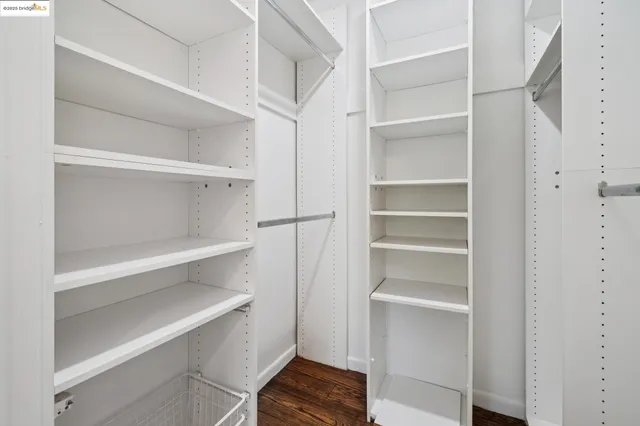 a view of walk in closet with empty racks