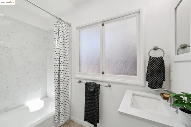 a bathroom with a bathtub and shower