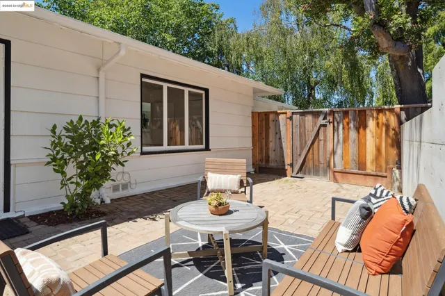 a backyard of a house with table and chairs