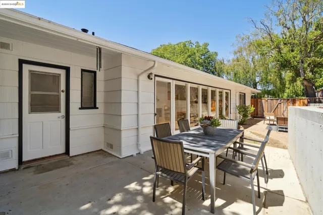 a view of a patio with table and chairs and potted plants