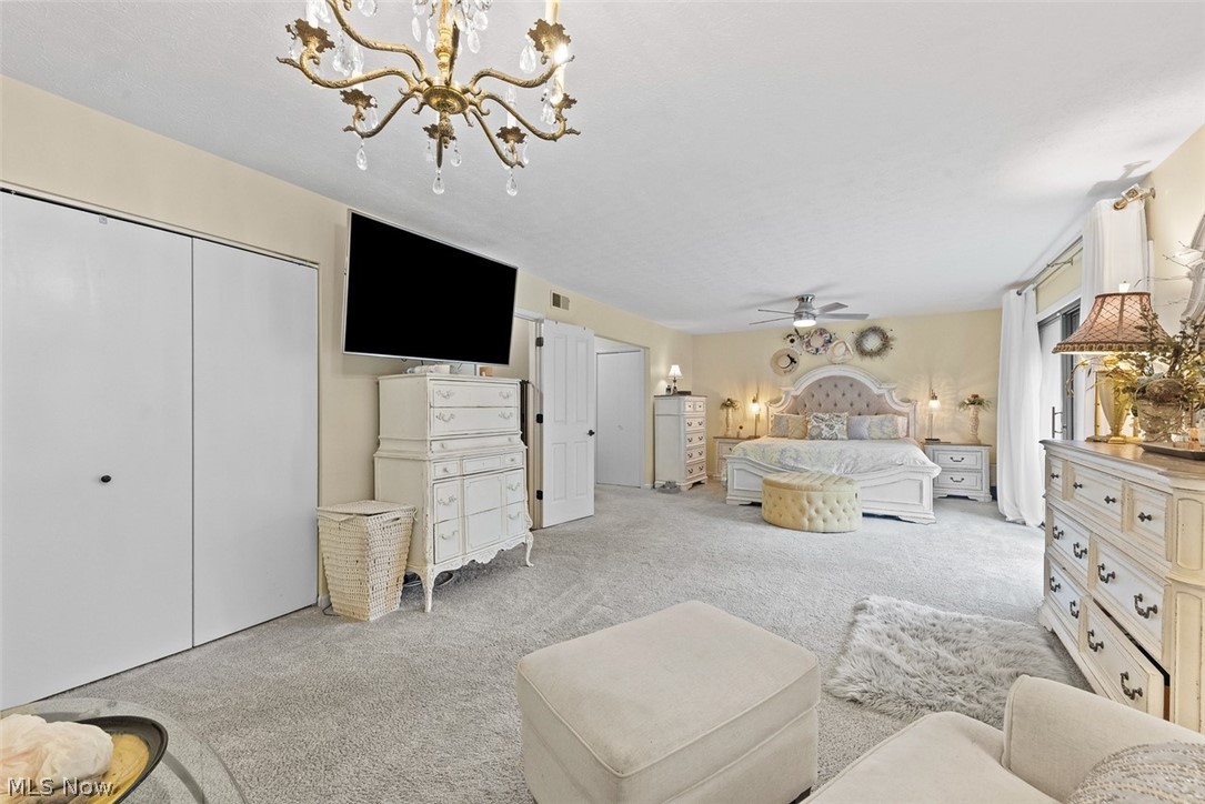 171 Granger Road, Unit 107 Medina, OH 44256 - Photo 27 of 41 Master bedroom carpeted featuring a ceiling-mounted chandelier, white bi-fold closet doors, and recessed lighting