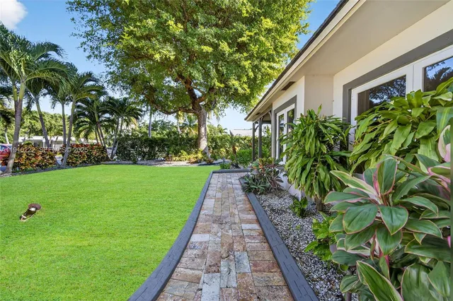 a kitchen with stainless steel appliances granite countertop a sink and a stove