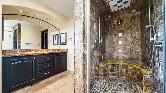 a bathroom with a sink a mirror and a shower