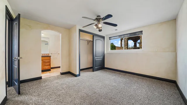 an empty room with windows and cabinet