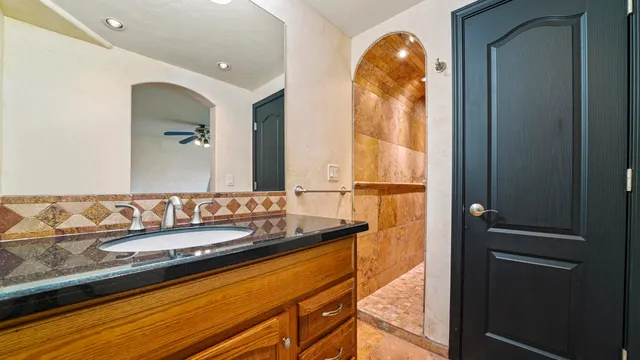 a bathroom with a mirror and a sink