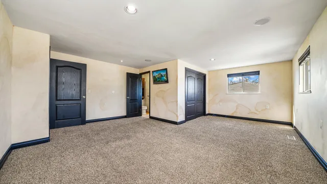 a view of an empty room with closet