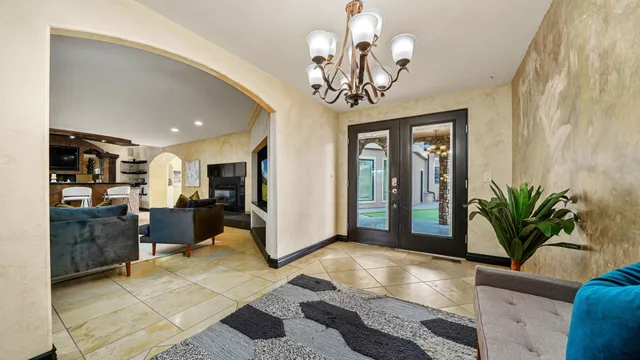 a living room with furniture and a chandelier