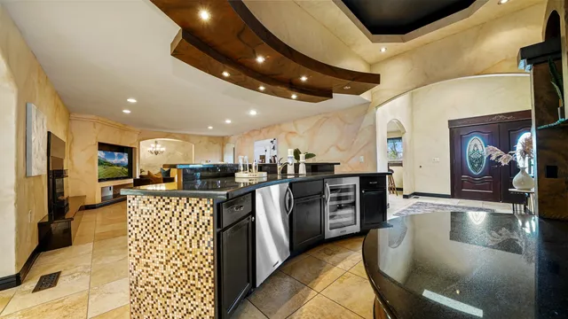 a kitchen with stainless steel appliances kitchen island granite countertop a stove and cabinets