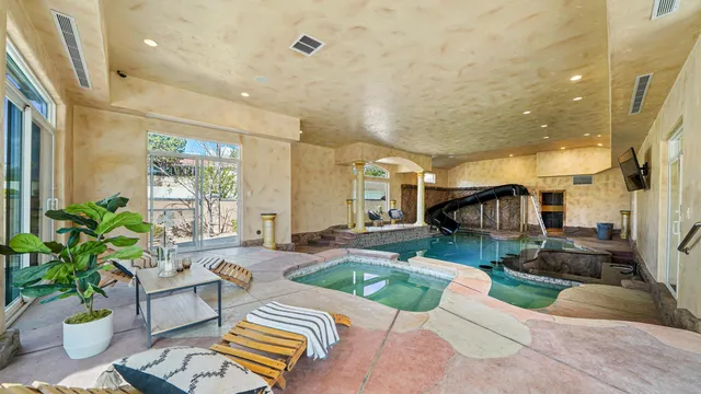 a living room filled with furniture and a potted plant