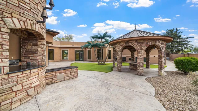 a view of house with backyard and outdoor seating