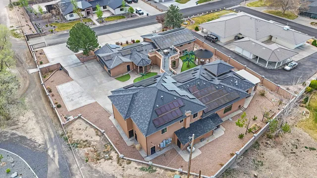an aerial view of residential house with yard and parking