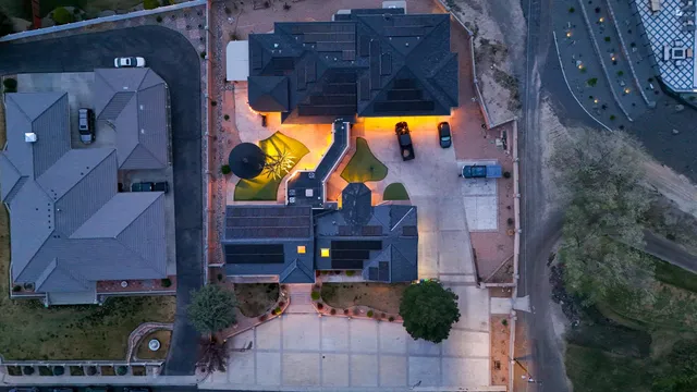 an aerial view of house with yard and swimming pool