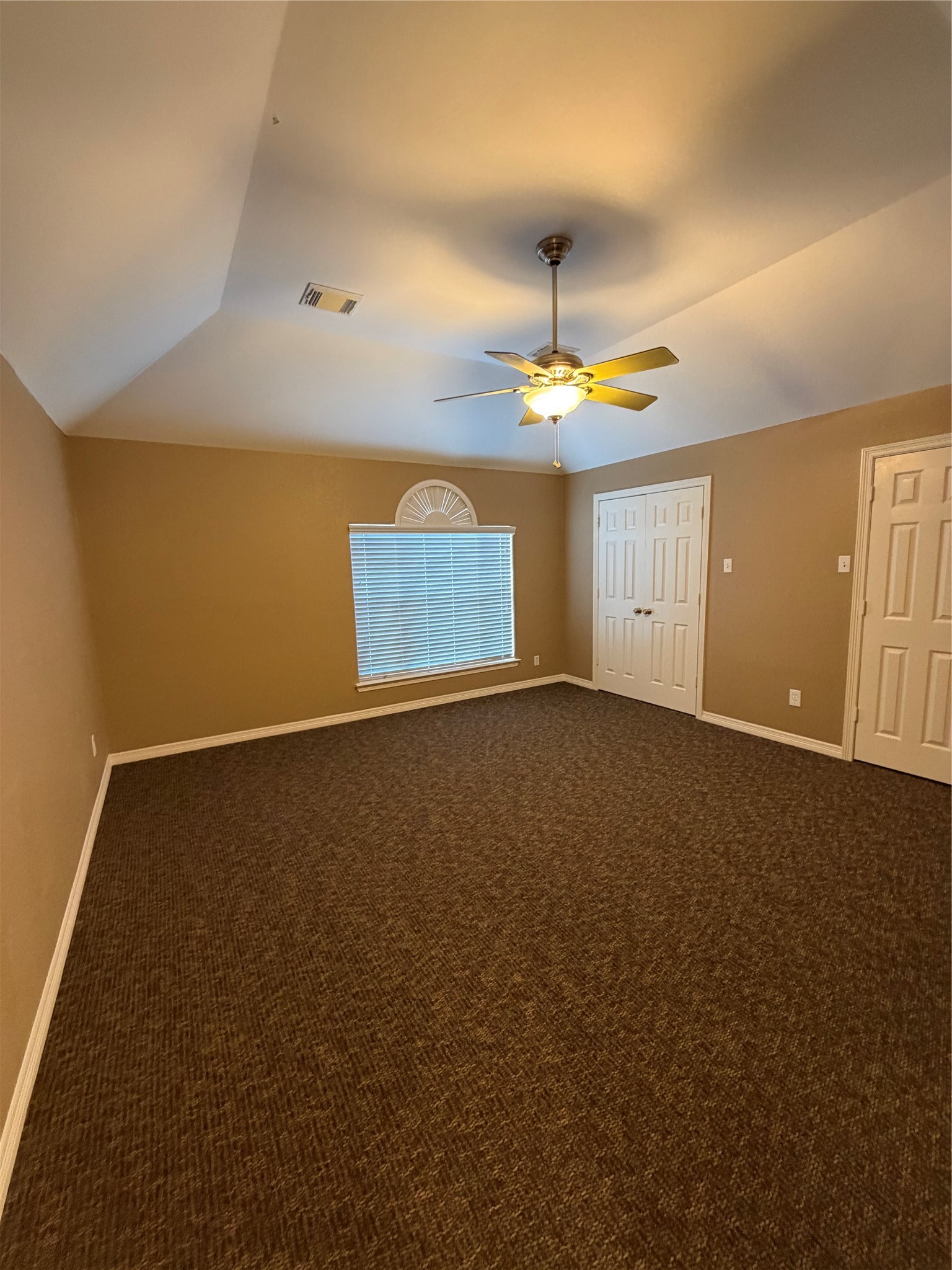 9110 Prairie Trails Drive Spring, TX 77379 - Photo 13 of 34 an empty room with a ceiling fan and window