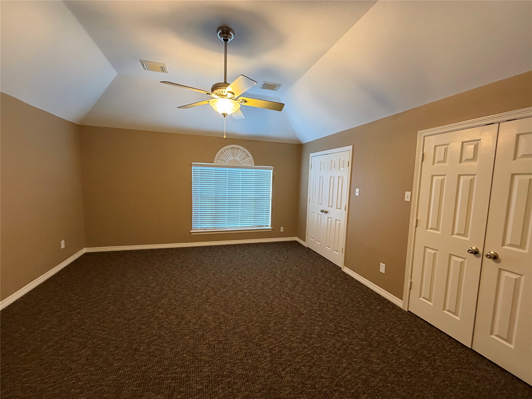 9110 Prairie Trails Drive Spring, TX 77379 - Photo 19 of 34 an empty room with windows and chandelier fan