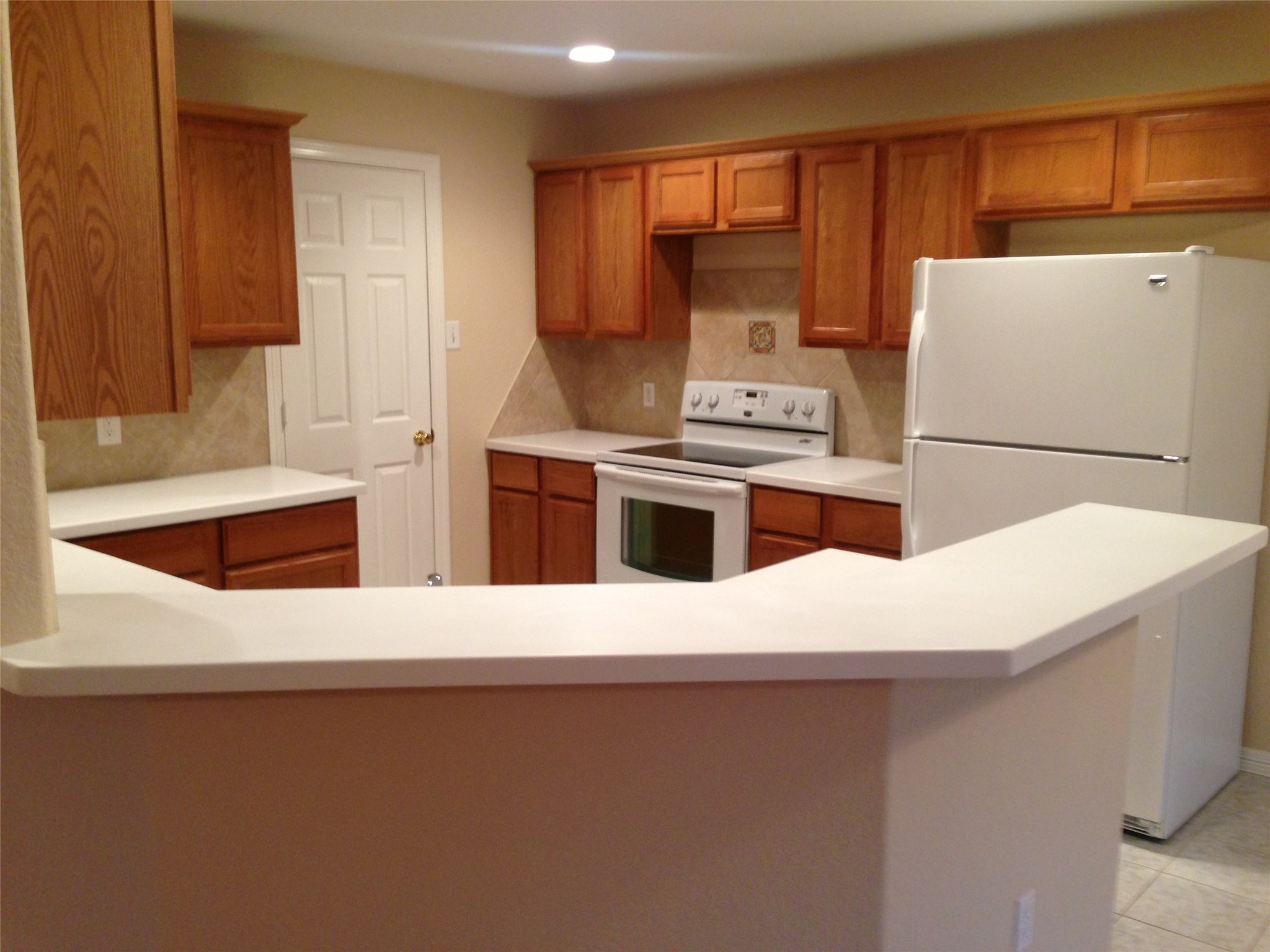 9110 Prairie Trails Drive Spring, TX 77379 - Photo 2 of 34 a kitchen with a white stove top oven and white countertops