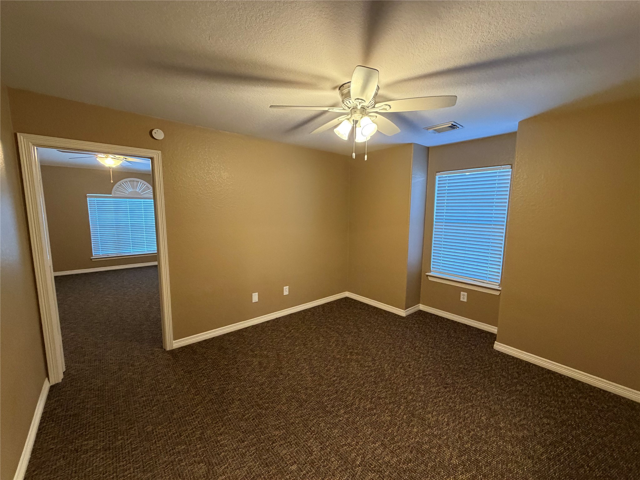 9110 Prairie Trails Drive Spring, TX 77379 - Photo 21 of 34 an empty room with windows and fan