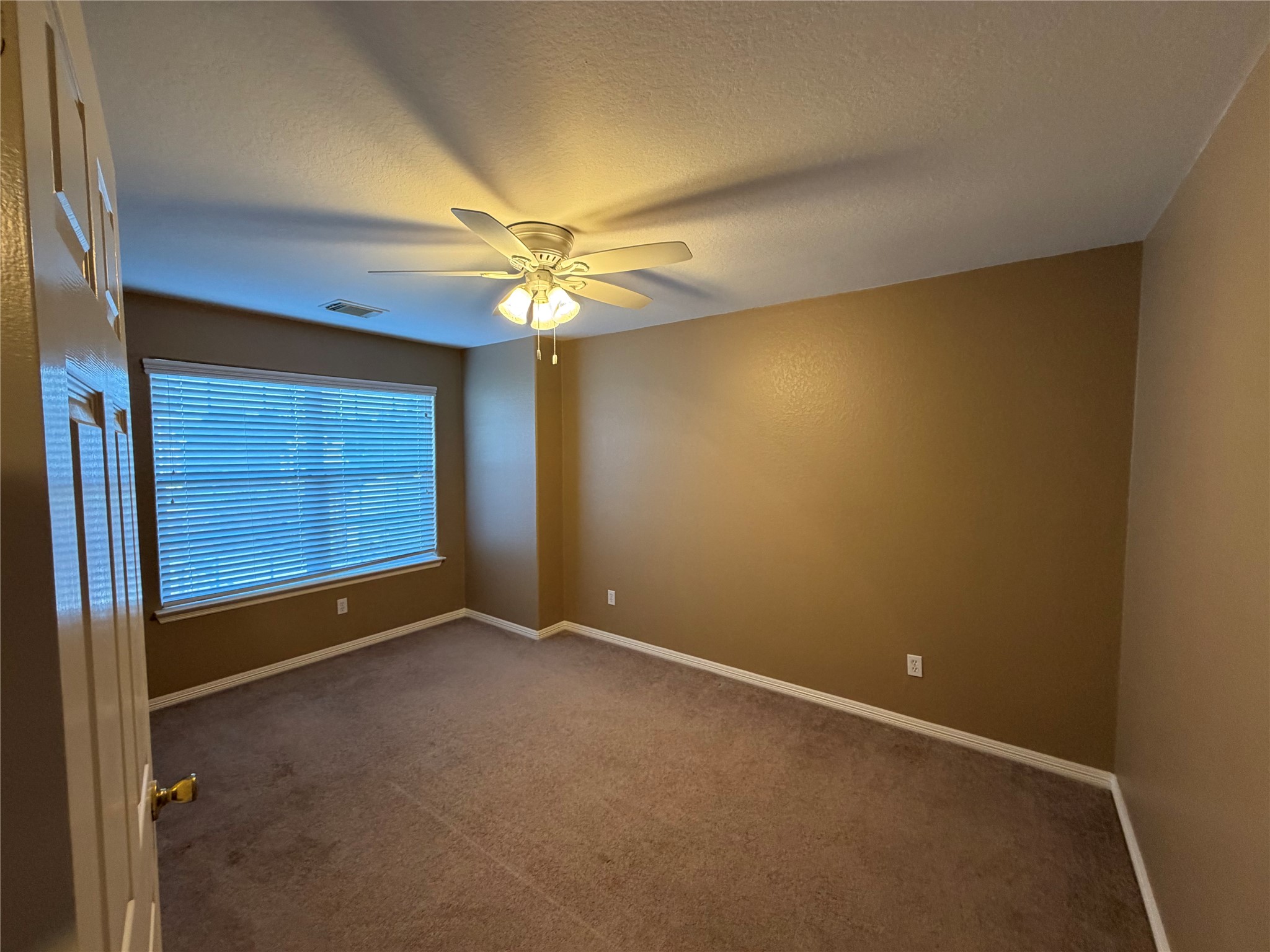 9110 Prairie Trails Drive Spring, TX 77379 - Photo 22 of 34 a view of an empty room with a window
