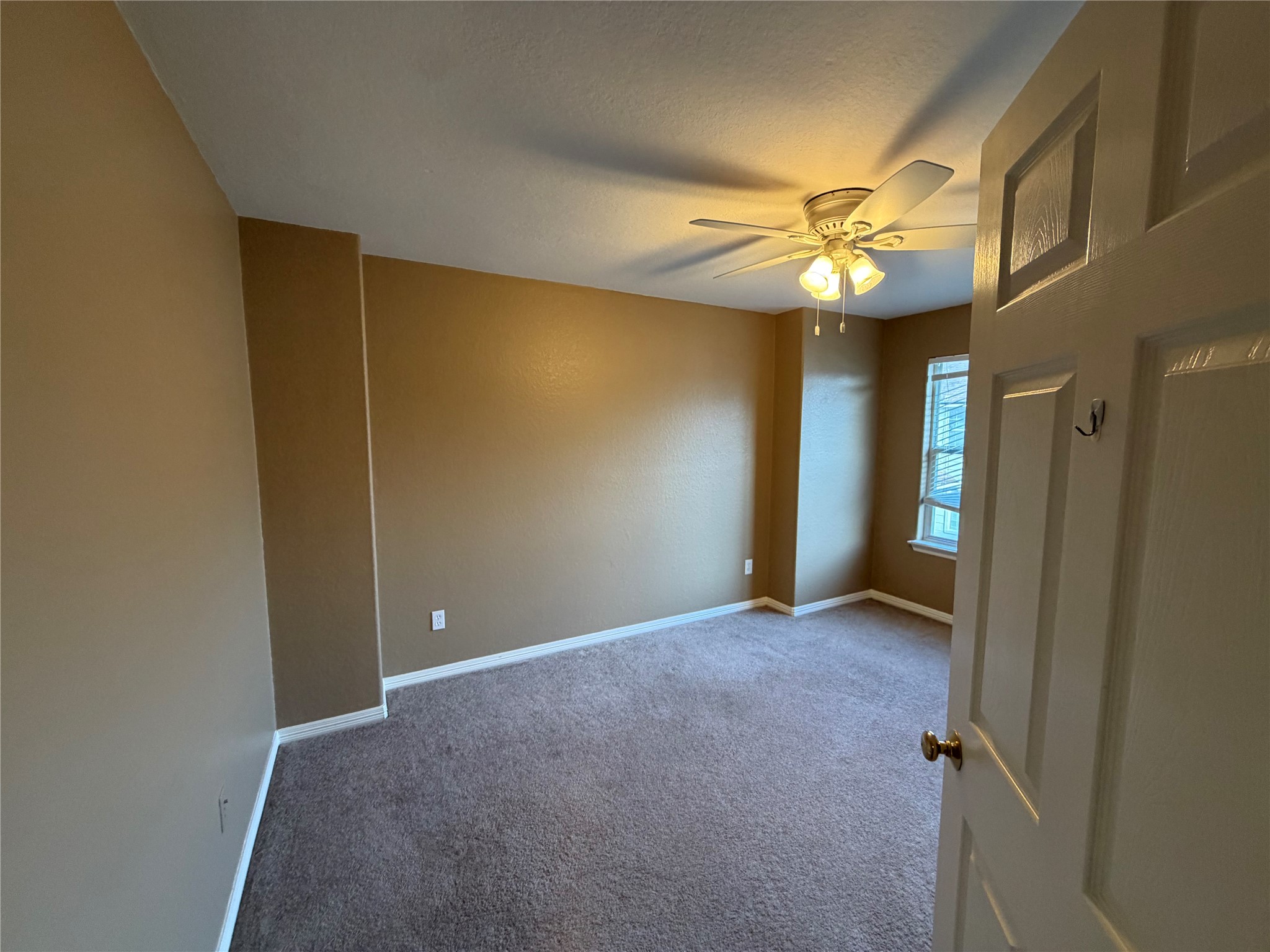 9110 Prairie Trails Drive Spring, TX 77379 - Photo 23 of 34 a view of an empty room with a fan