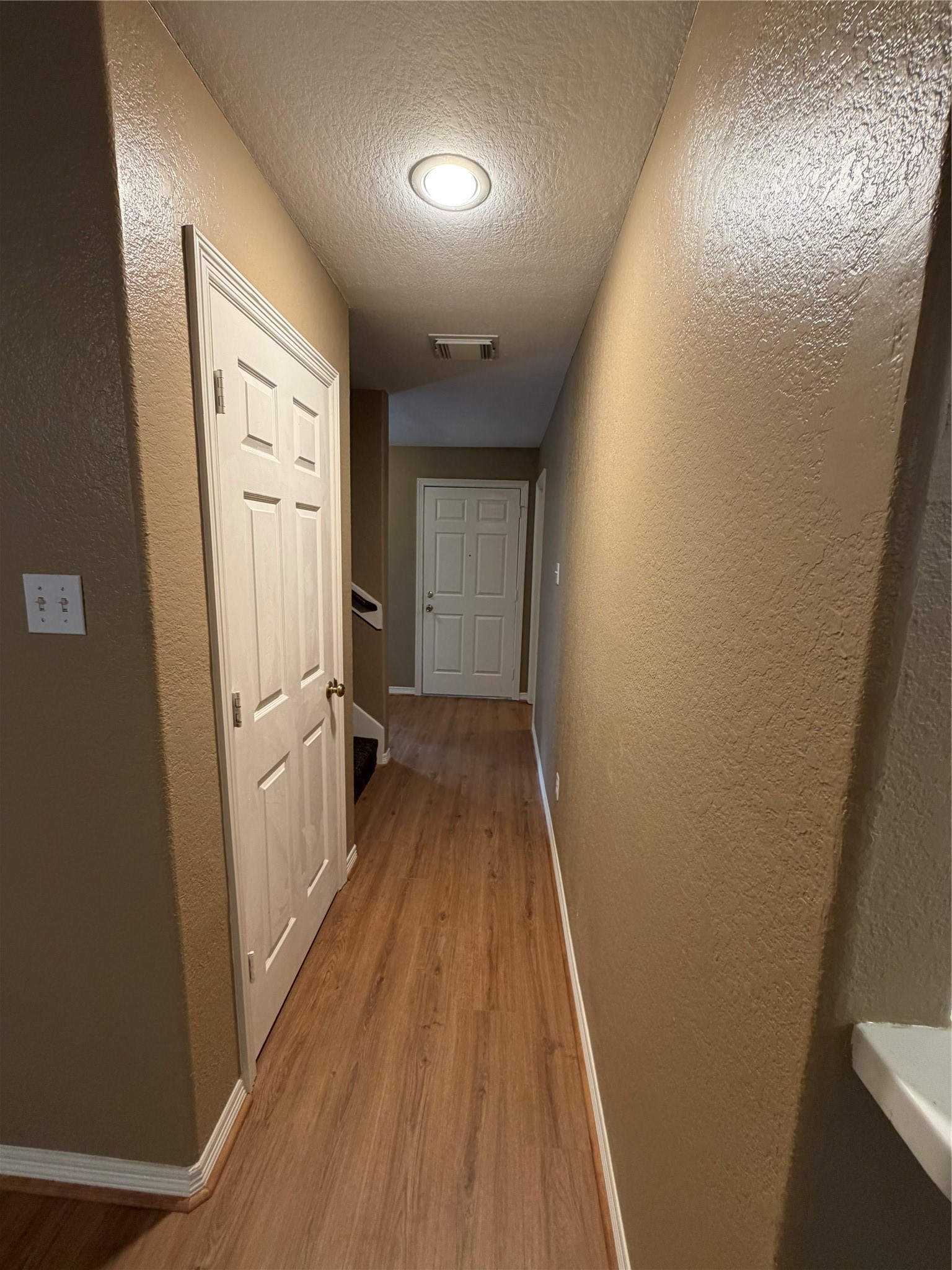 9110 Prairie Trails Drive Spring, TX 77379 - Photo 27 of 34 a view of a hallway with wooden floor