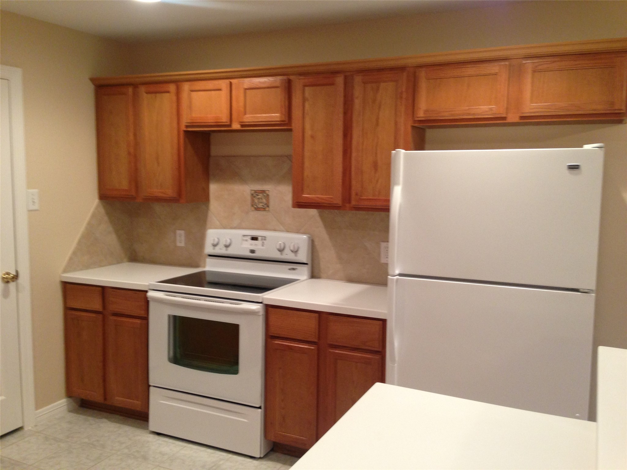 9110 Prairie Trails Drive Spring, TX 77379 - Photo 3 of 34 a white refrigerator freezer and a stove sitting inside of a kitchen