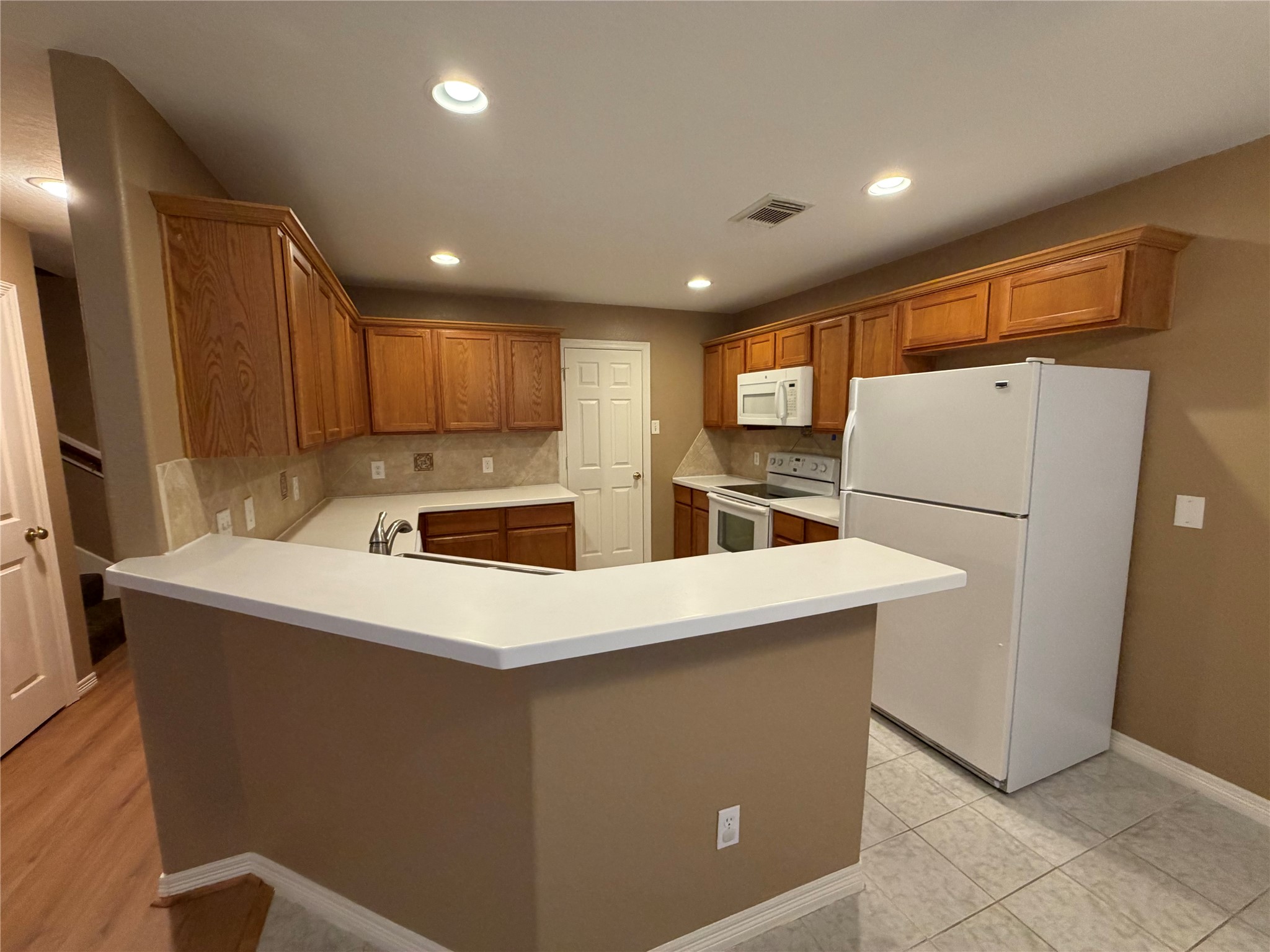 9110 Prairie Trails Drive Spring, TX 77379 - Photo 31 of 34 a kitchen with refrigerator and cabinets
