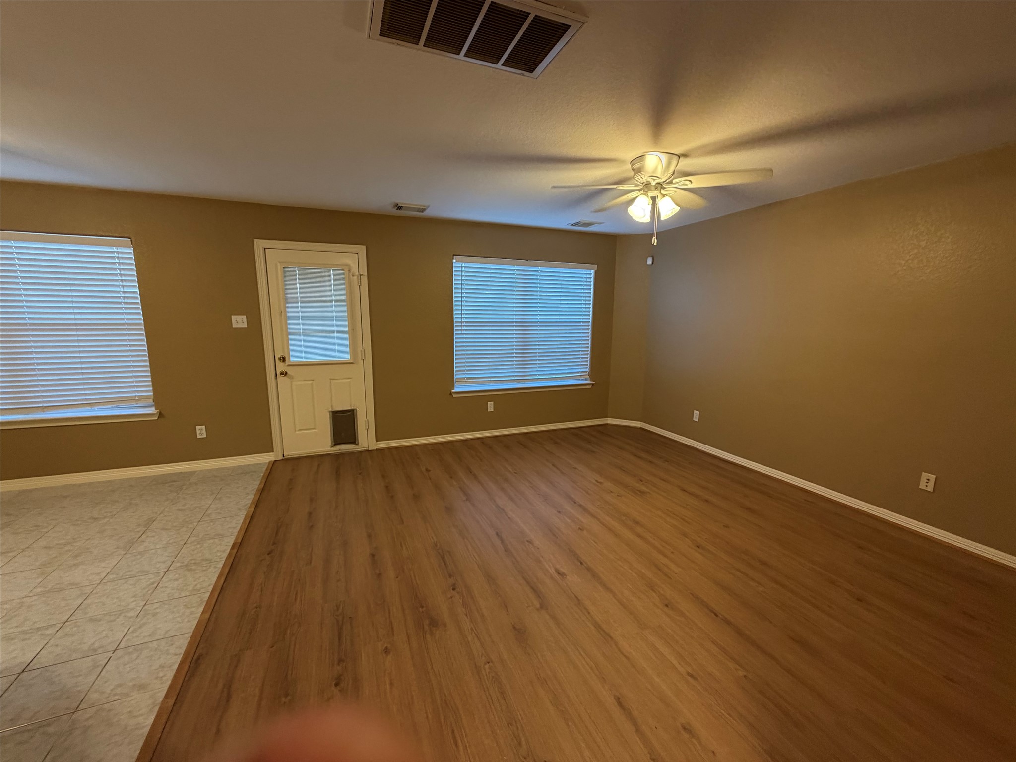 9110 Prairie Trails Drive Spring, TX 77379 - Photo 34 of 34 wooden floor in an empty room with a window