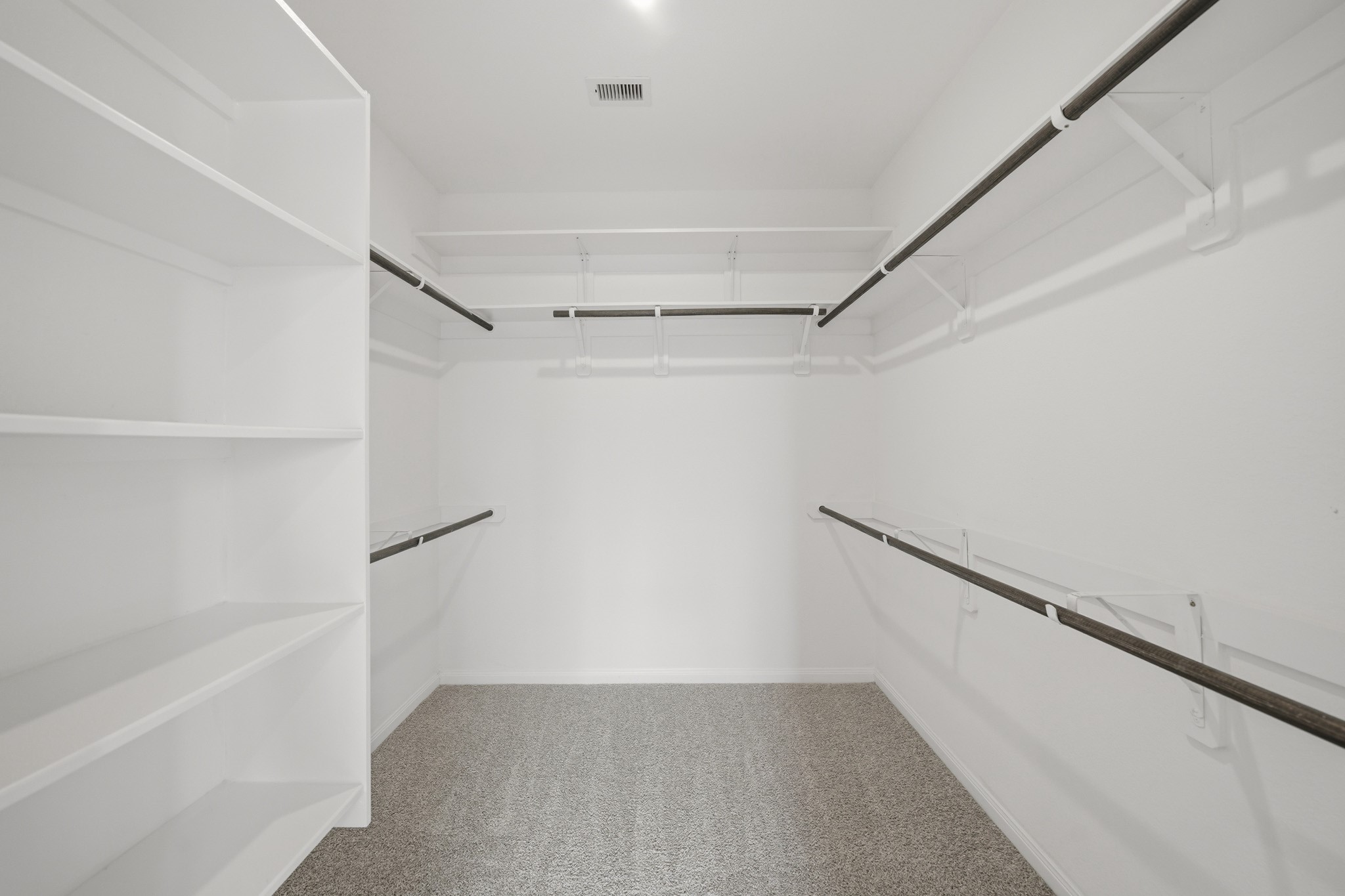 4103 Tranquil Square Road Houston, TX 77043 - Photo 25 of 39 This well-appointed primary closet with dual shelf and hanging systems and custom shoe storage has plenty of room. A private water closet enhanced by an overhead cabinet for added functionality is just outside.