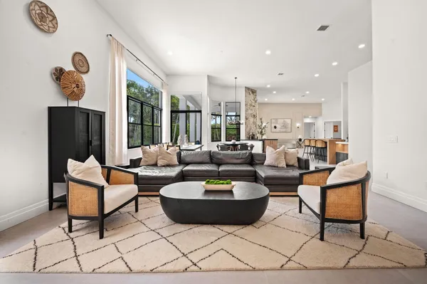 a living room with furniture a rug and a clock