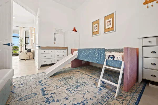 a living room with furniture and a dresser