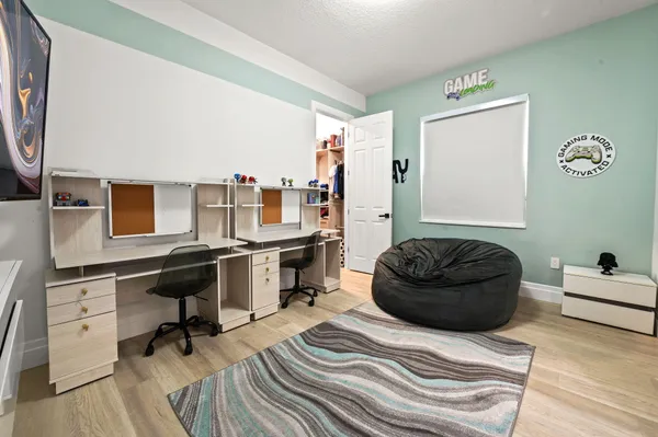 a bedroom with a bed and a desk