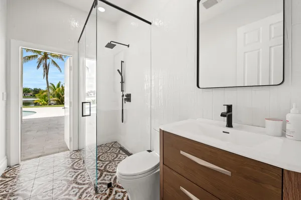 a bathroom with a sink a toilet and shower