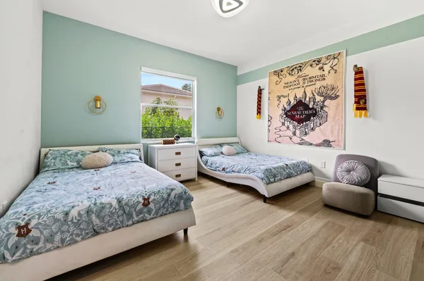 a bedroom with a bed couch and window