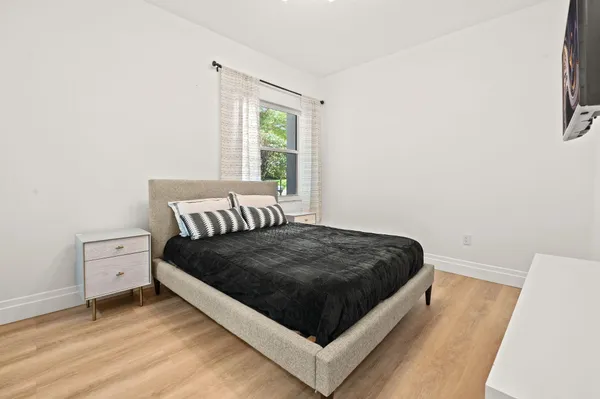 a bed sitting in a bedroom next to a window