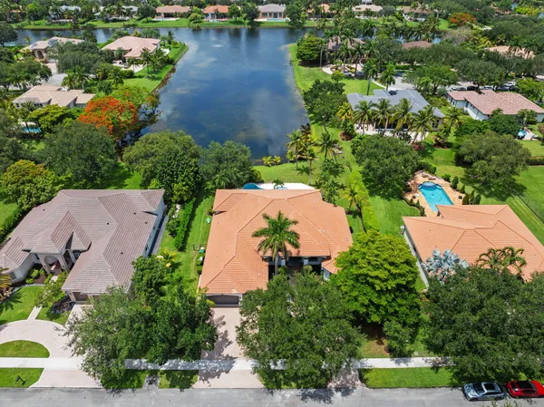 an aerial view of a house with a garden and lake view