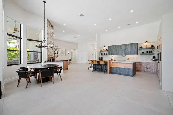 a living room with furniture and kitchen area