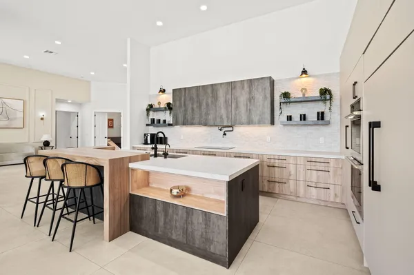 a kitchen with a sink stove and refrigerator