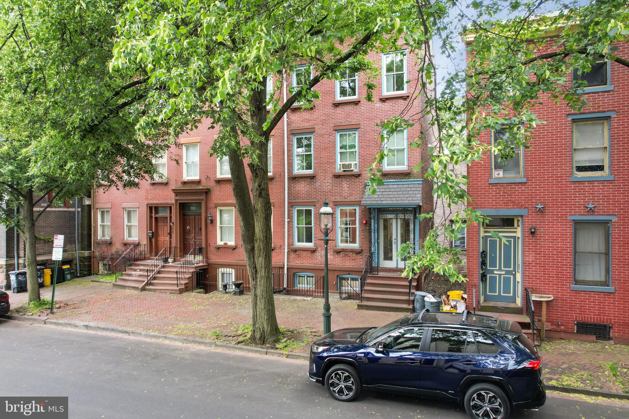 a car parked in front of a brick house