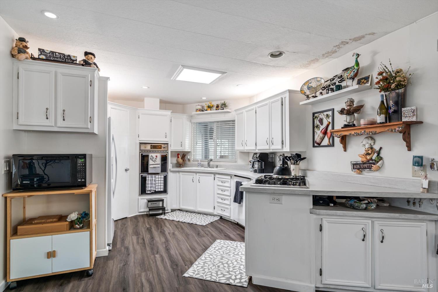 192 Mosshill Court Santa Rosa, CA 95409 - Photo 11 of 31 a kitchen with granite countertop a stove and cabinets