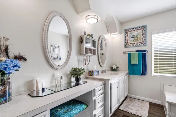 a bathroom with a sink mirror and vanity