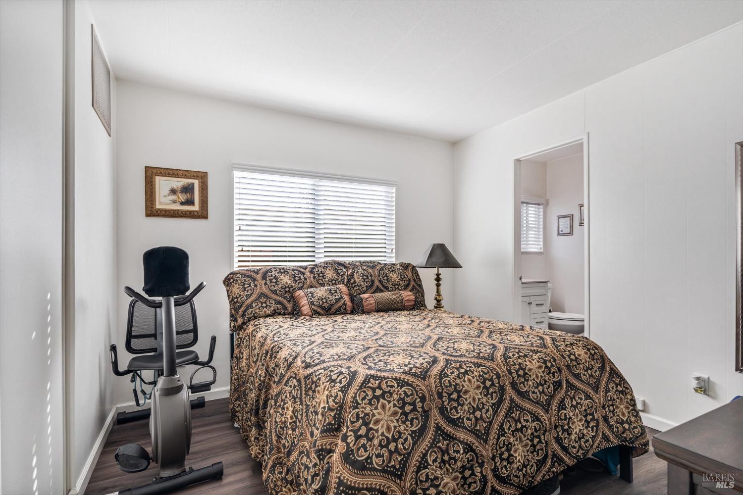 192 Mosshill Court Santa Rosa, CA 95409 - Photo 20 of 31 a bedroom with a bed and a lamp next to a window