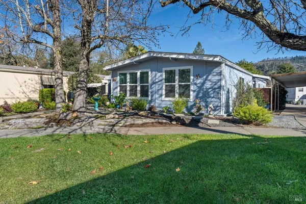 a view of a house with backyard sitting area and garden