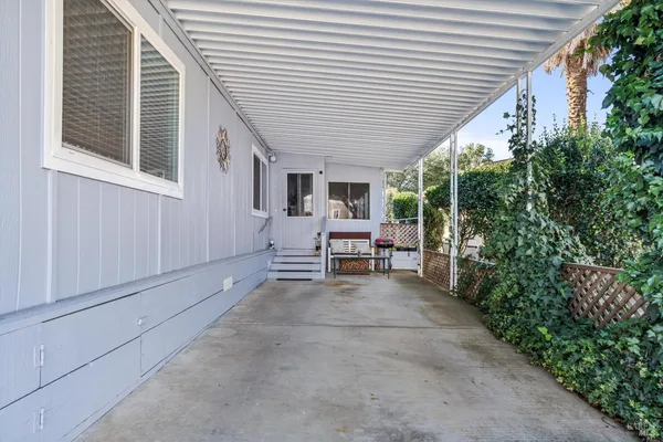 a view of a house with backyard and sitting area
