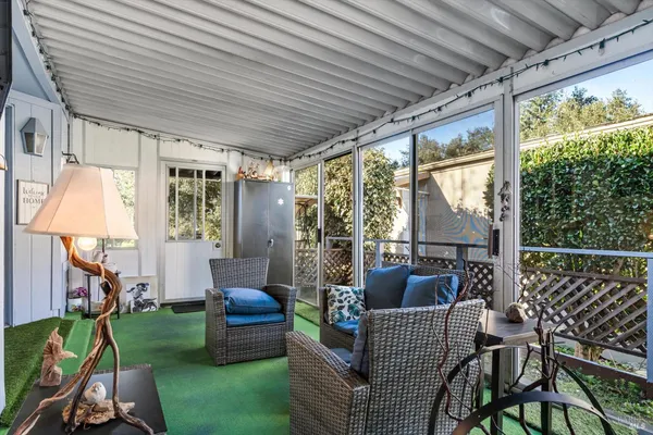 a balcony with furniture and a garden