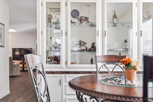 a dining room with furniture and wooden floor